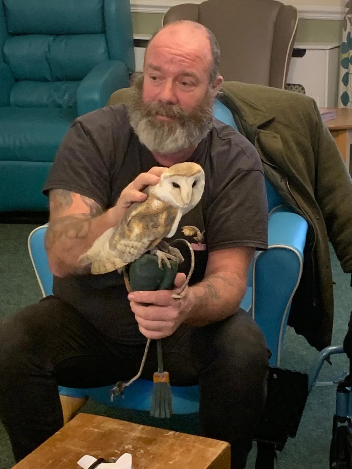 A resident holding a rabbit during a pet therapy visit at Broadland House.